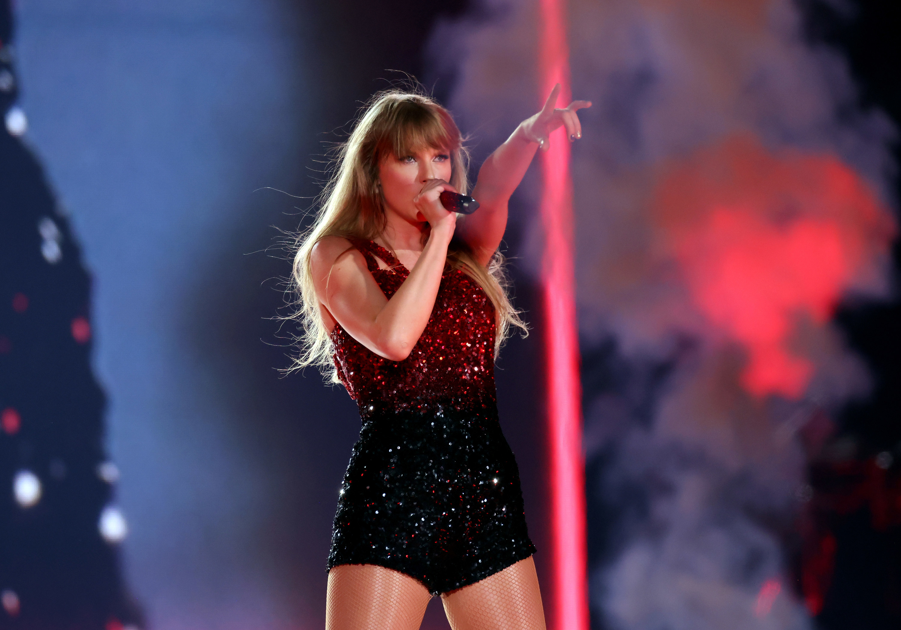 Taylor Swift wearing a sparkly red body suit