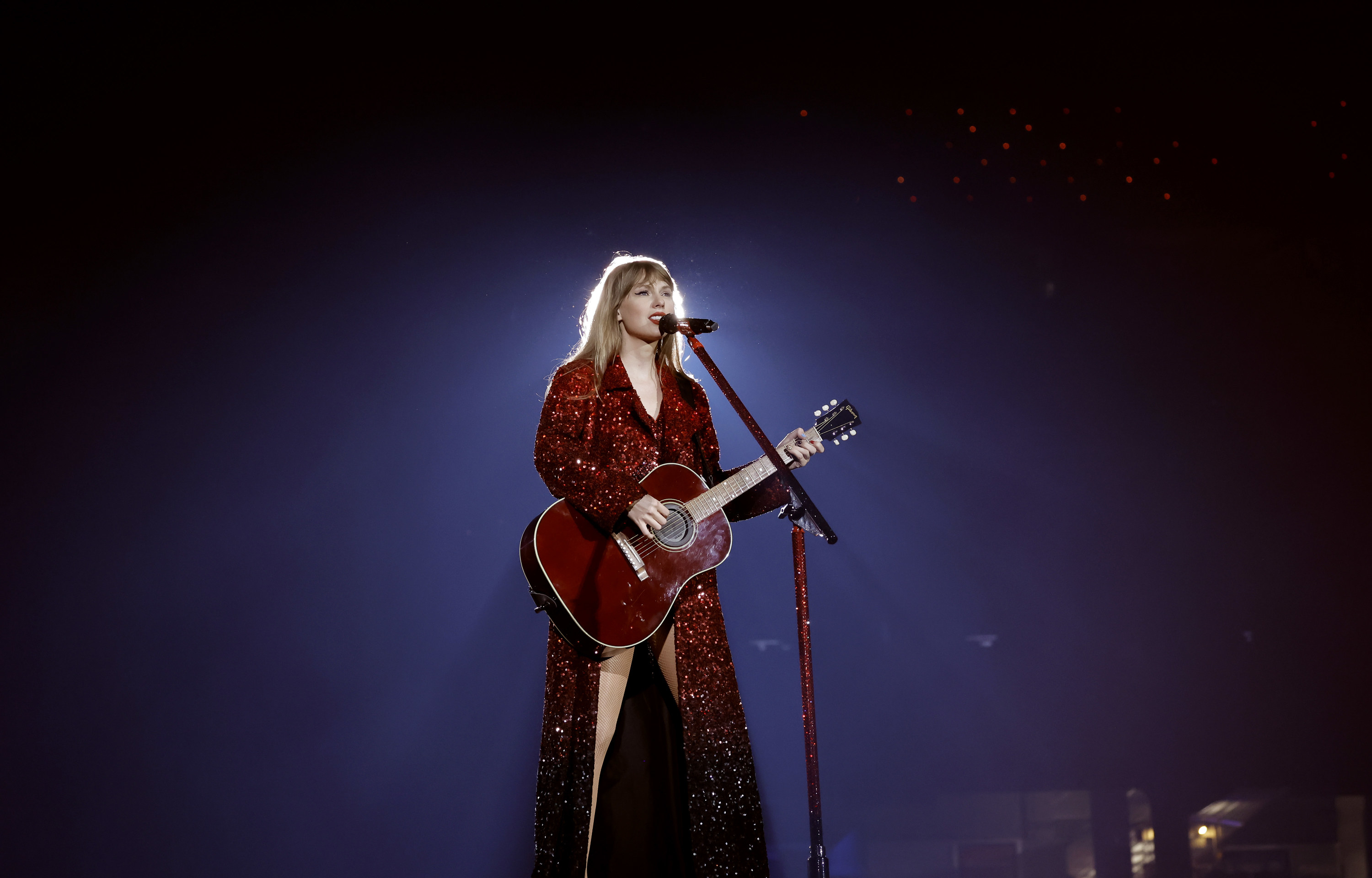 Taylor Swift wearing a red jacket dress