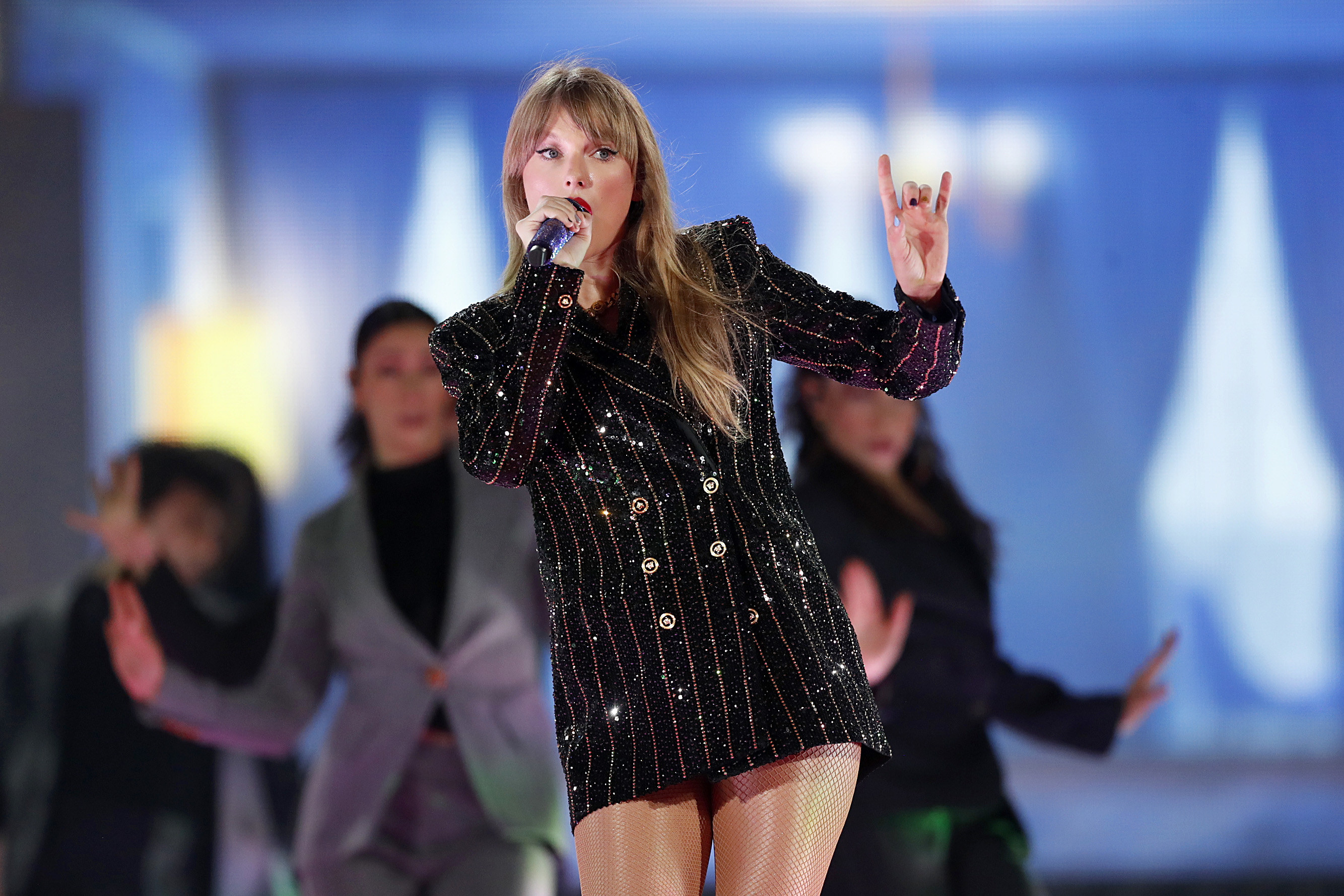 Taylor Swift wearing a sparkly black jacket dress