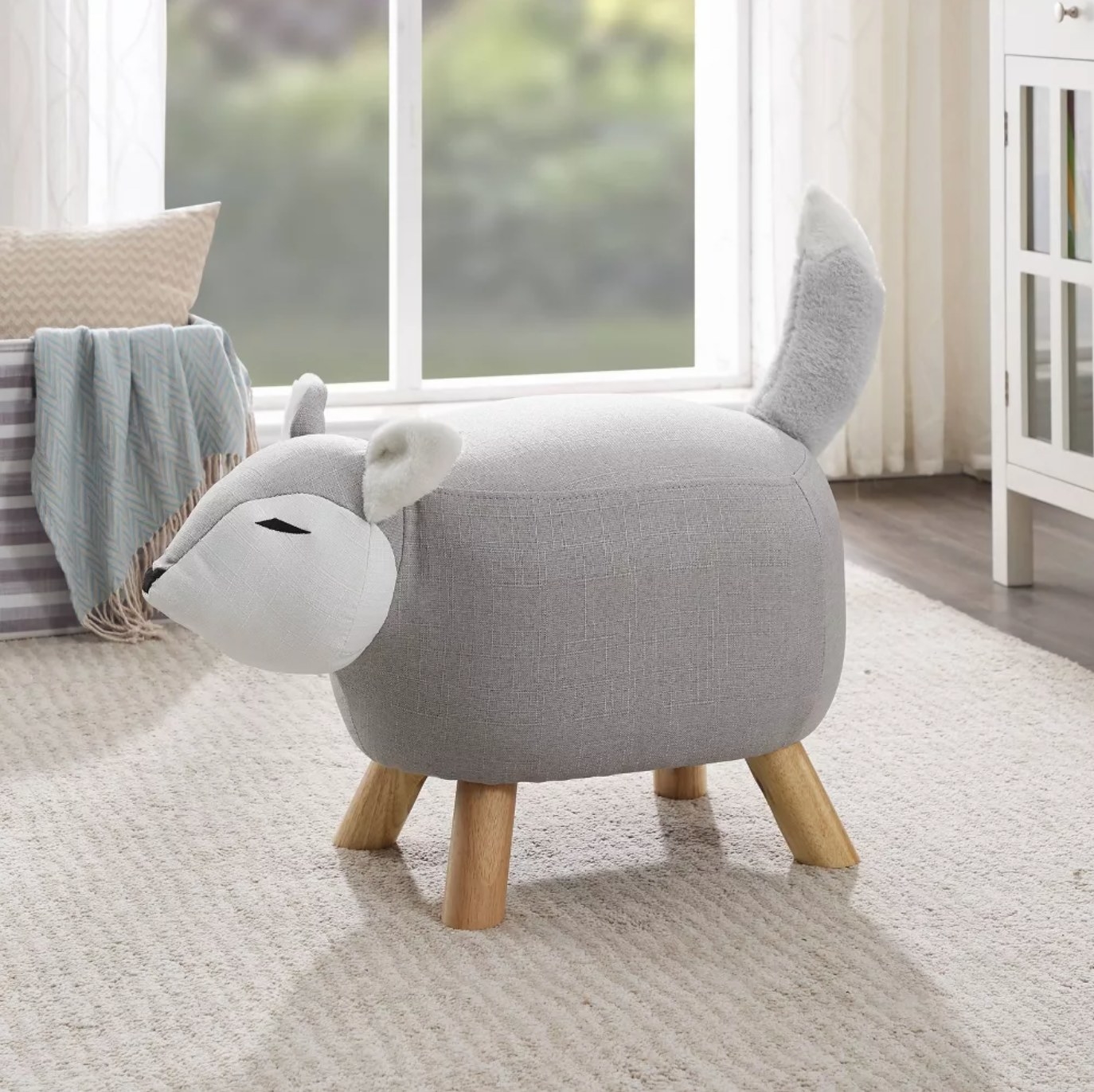 a plush fox stool with wooden legs on a low pile rug