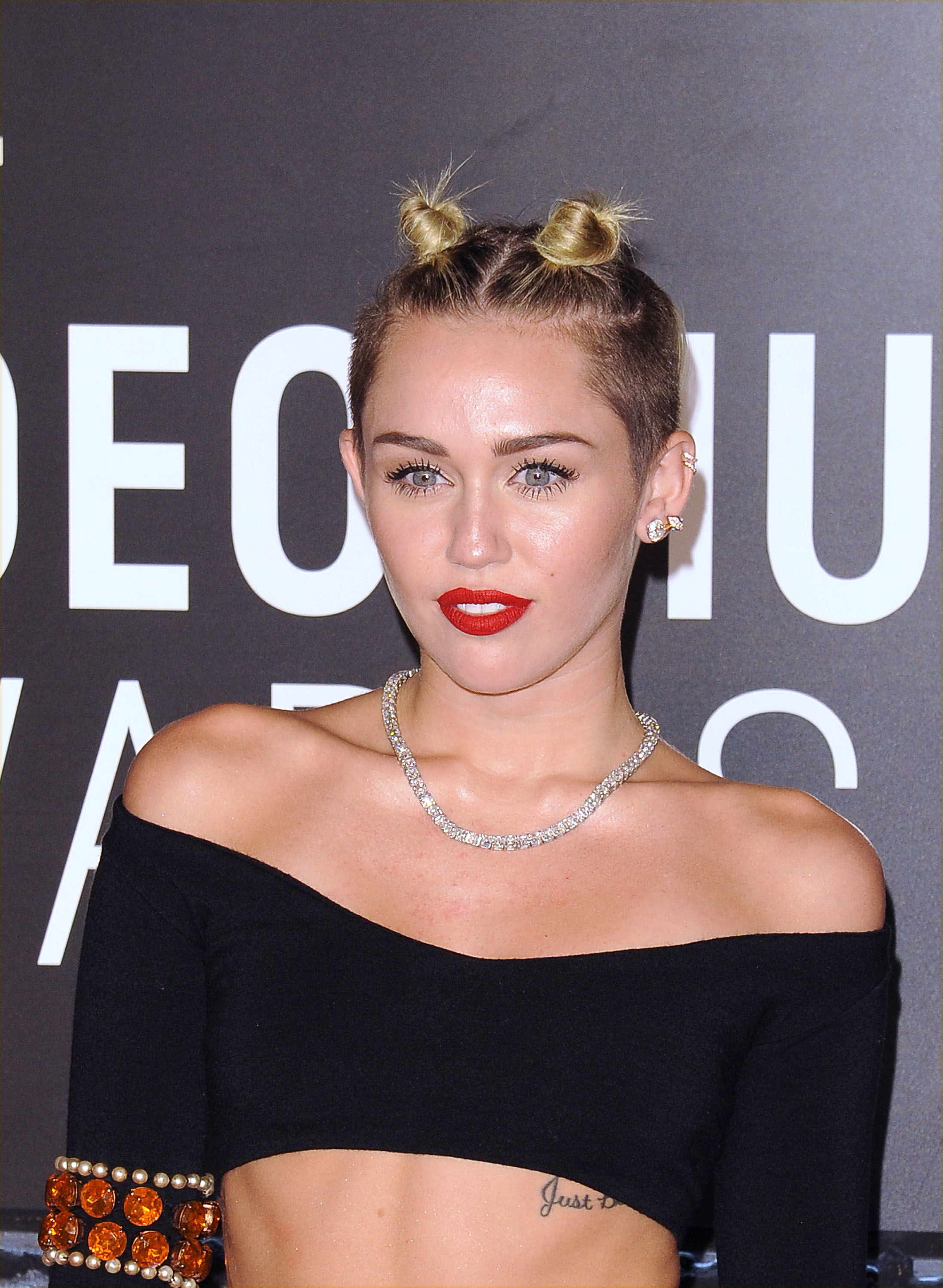 Close-up of Miley in an off-the-shoulder crop top