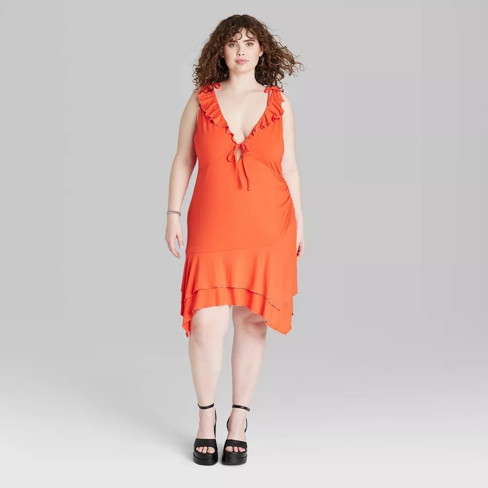 A model in the orange ruffled dress