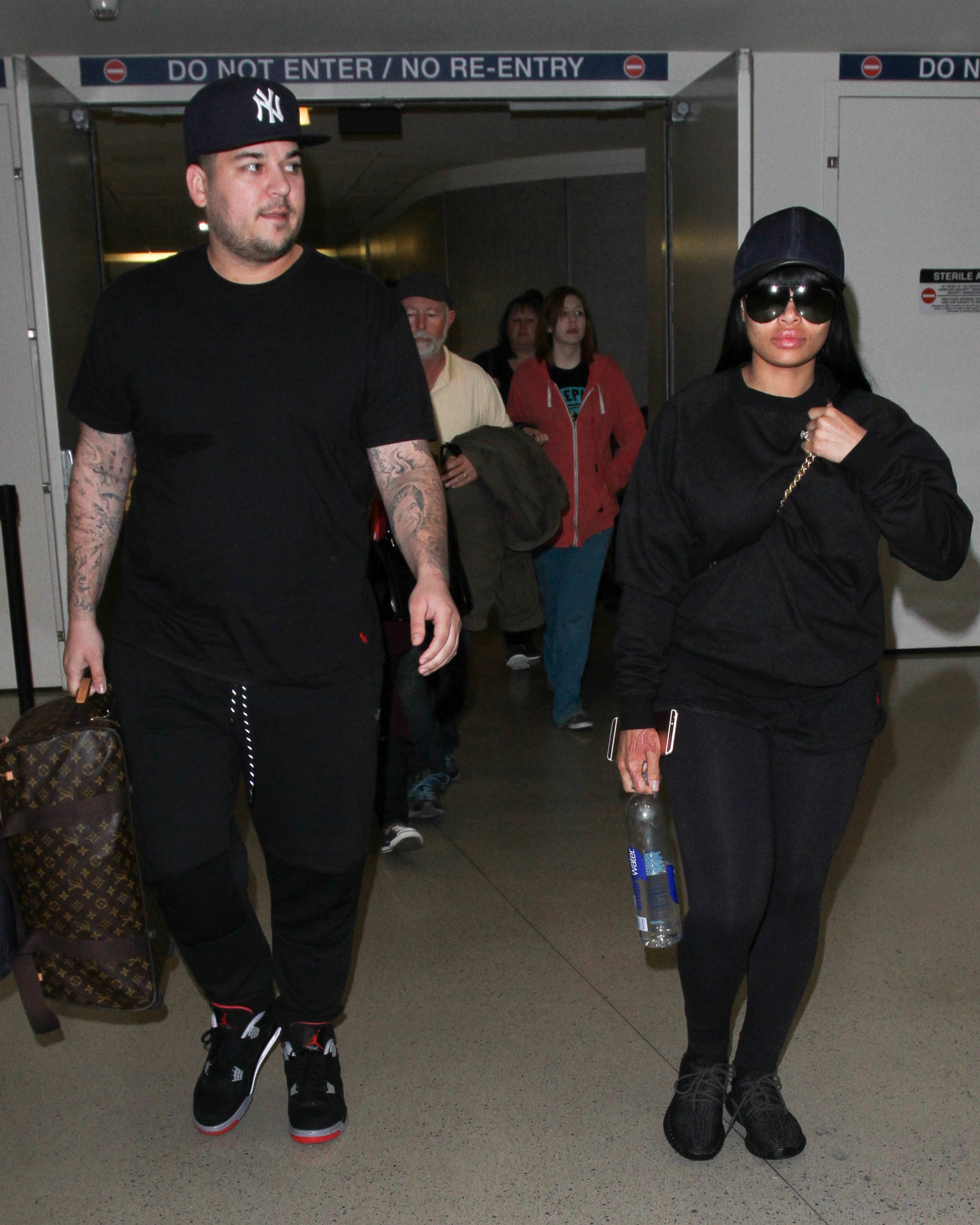 Rob and Chyna walking through an airport