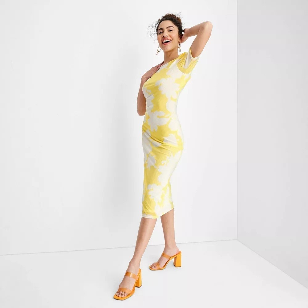 A model in the yellow and white floral dress