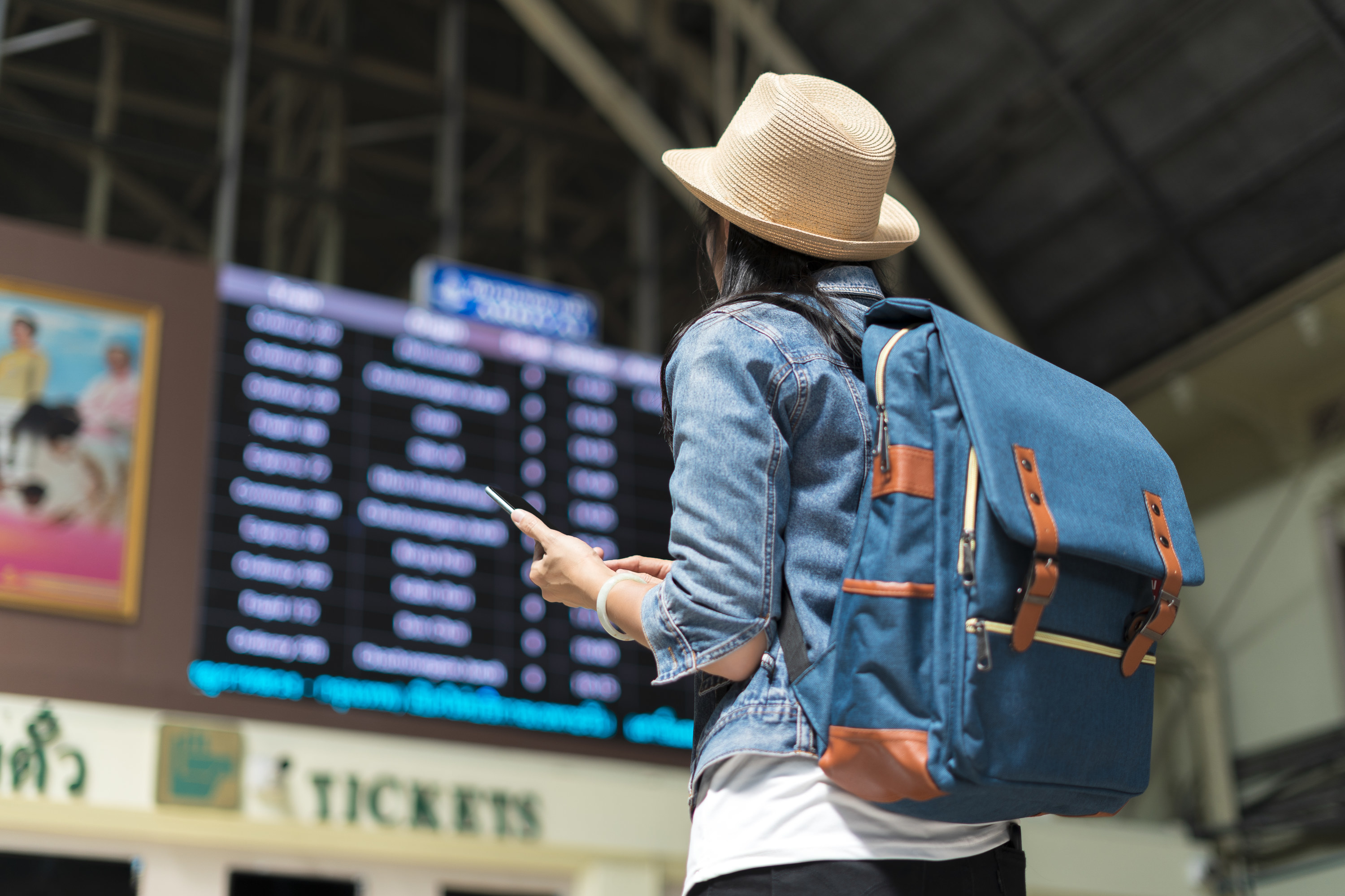 A woman traveling and look at departure times