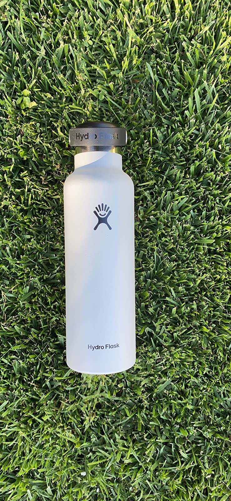 The white hydroflask in grass