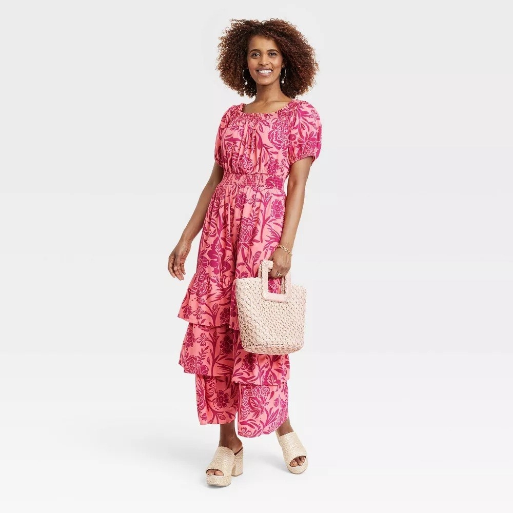 A model in the pink floral maxi dress