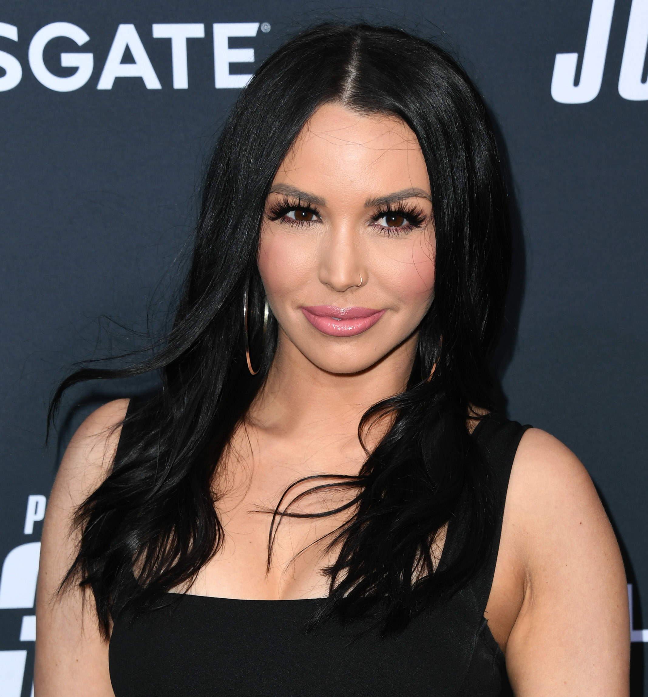 Scheana Shay poses at a movie premiere, with massive eyelashes and big lips