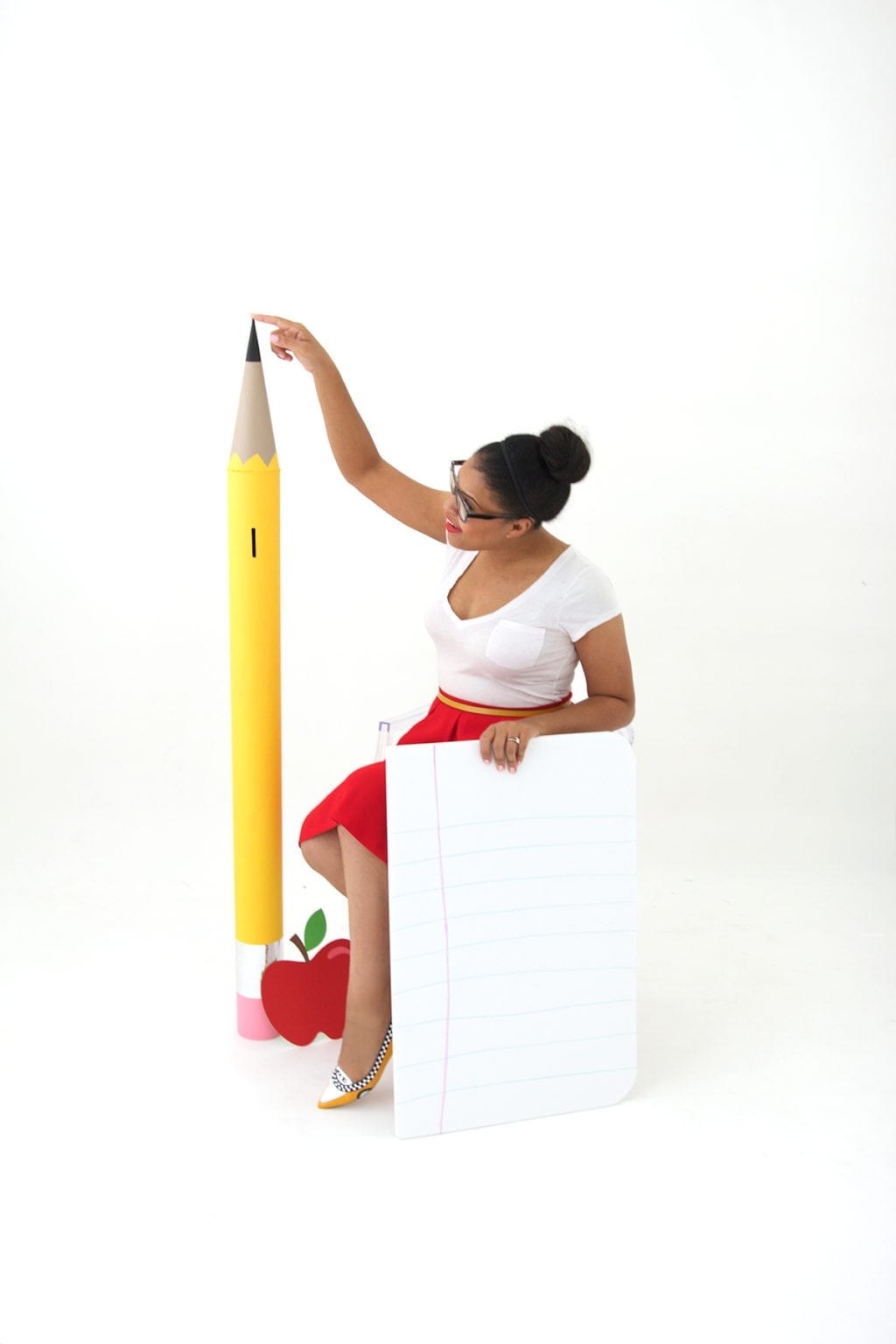 Woman with a giant yellow pencil