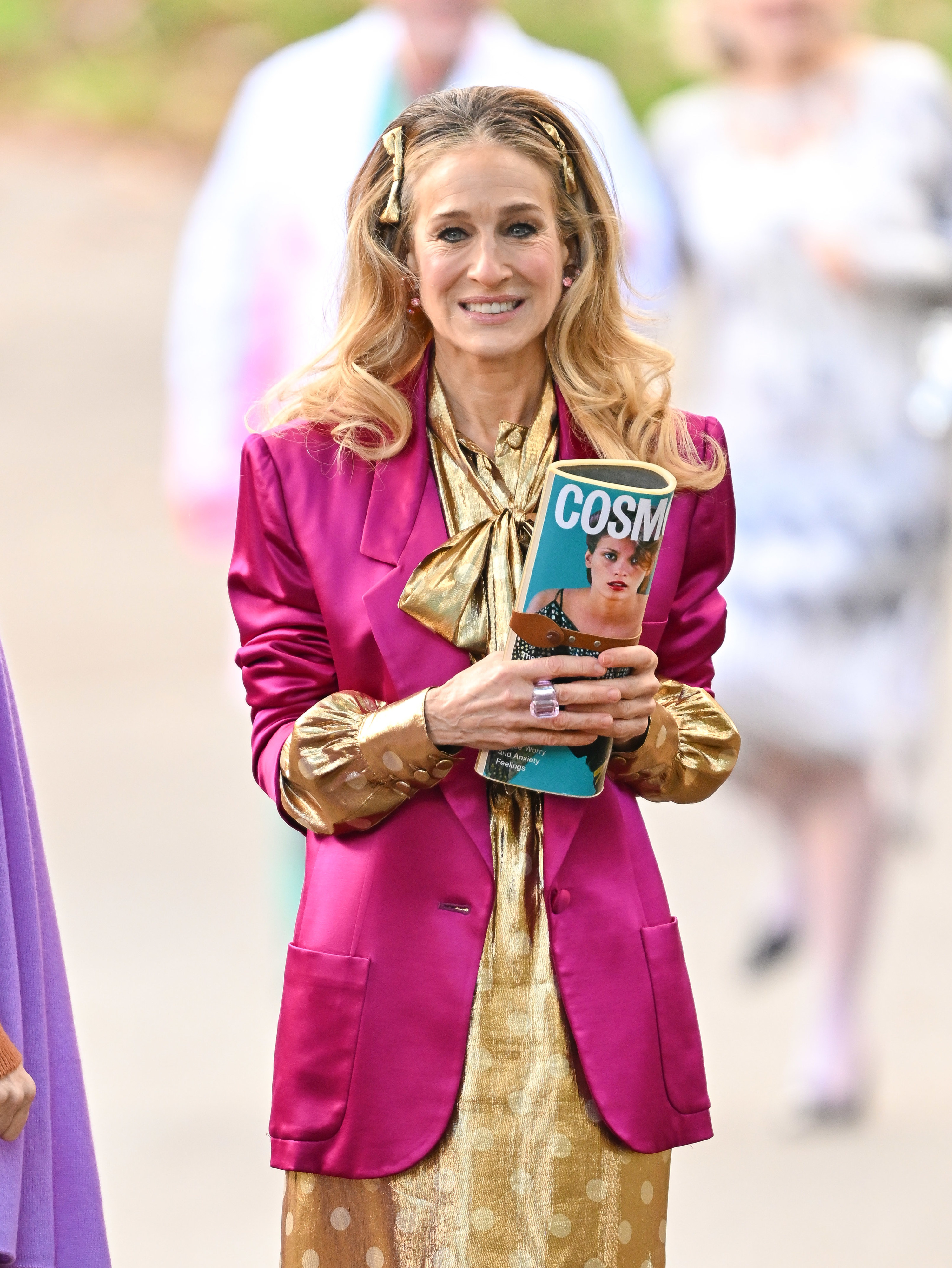 Sarah Jessica Parker on the set of &#x27;And Just Like That&#x27;, wearing a bright pink blazer and gold dress - her chin mole isn&#x27;t visible