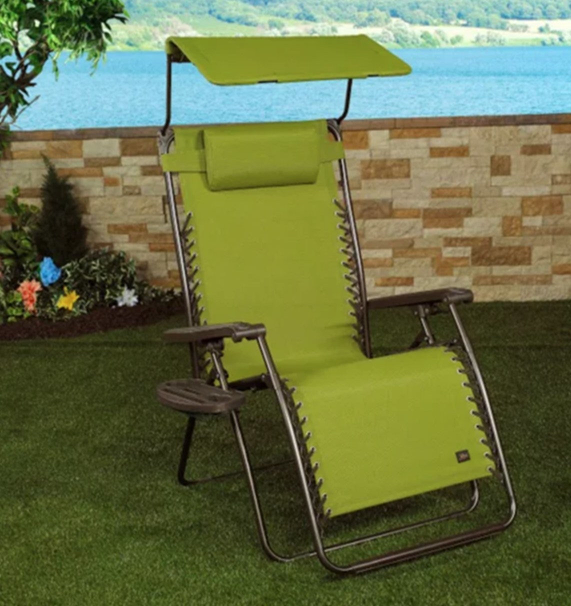 the green outdoor chair with a shade in a decorated backyard space
