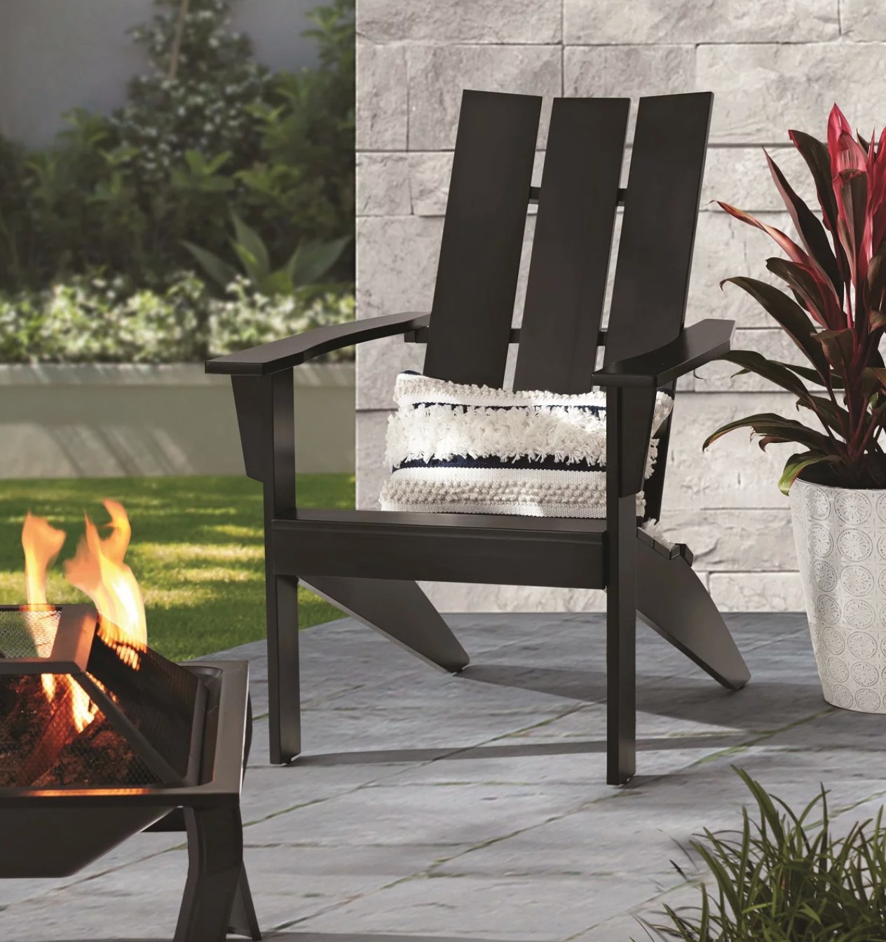 the black adirondack chair in a decorated patio space