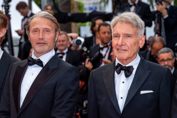 Harrison Ford standing next to Mads Mikkelson on the red carpet of Cannes