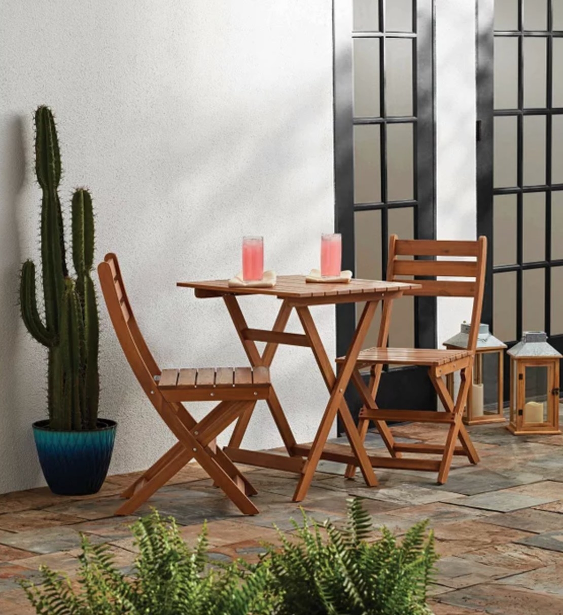 the medium wood table and chairs in a decorated patio space