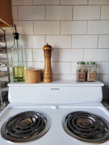 various items on an editor's white apartment size stoveshelf