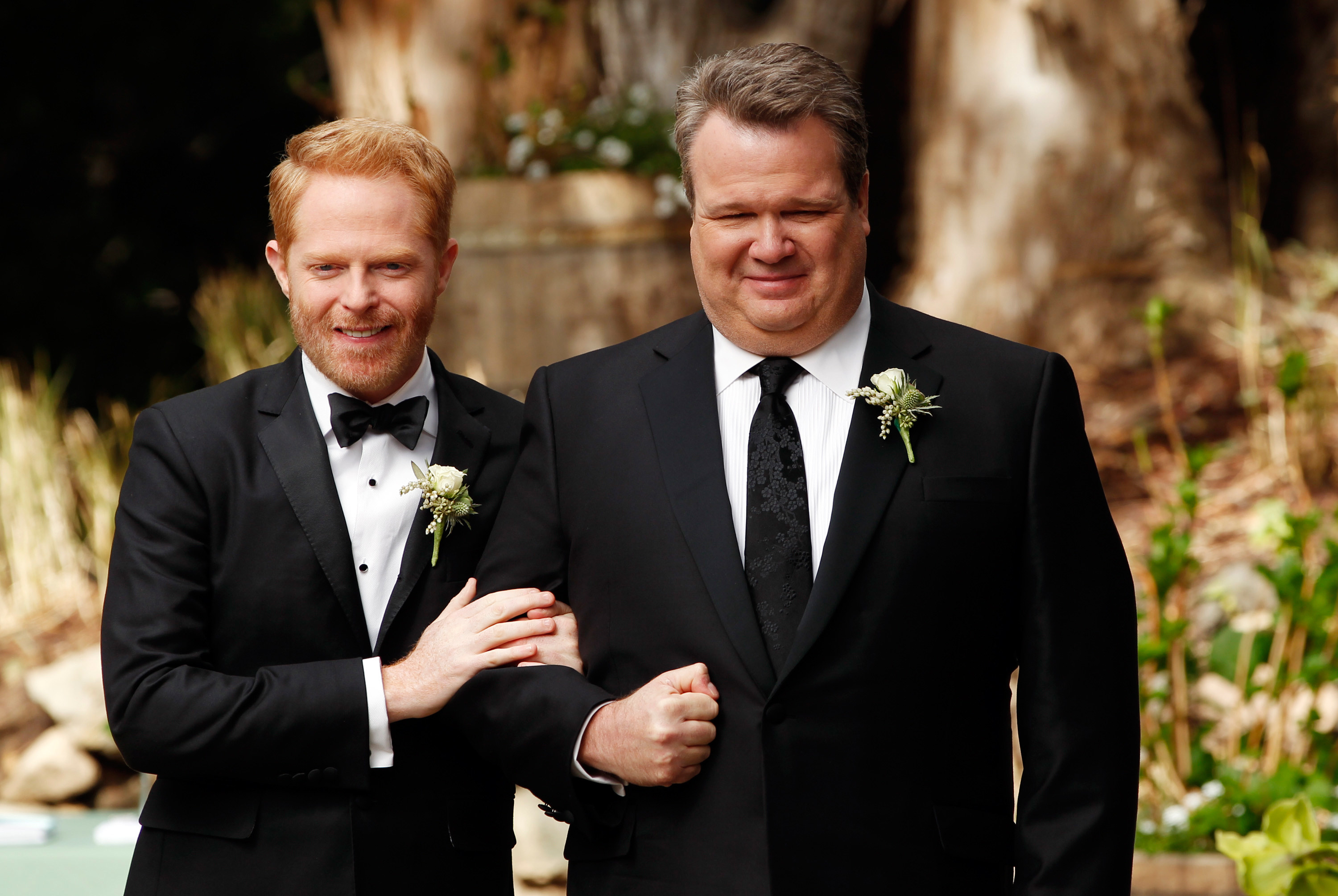 Mitchell and Cameron hold each other tightly at a wedding