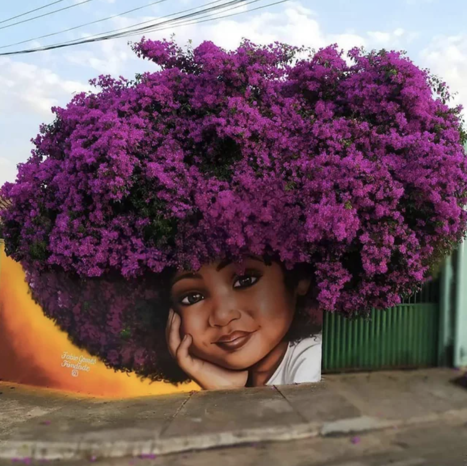 A mural on a wall with flowers serving as the hair