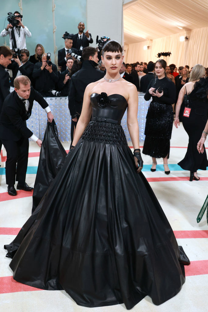 Lily James attends The 2023 Met Gala in a black leather gown