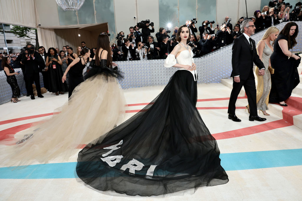 Lily Collins attends The 2023 Met Gala in a gown that says "KARL" on the train