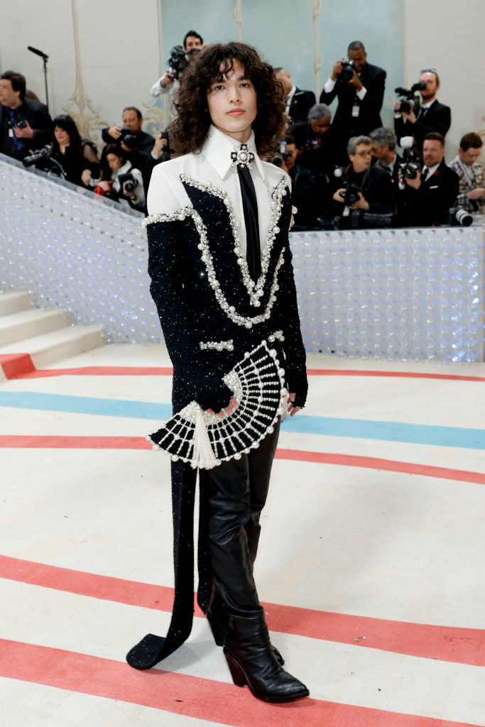 Conan Gray attends The 2023 Met Gala in leather pants and a white shirt