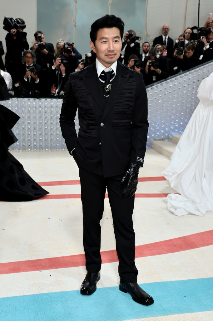 Simu Liu attends The 2023 Met Gala in a black suit