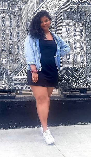 reviewer wearing achromatic workout formal with denim overgarment implicit it