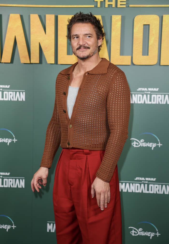 Pedro Pascal in red pants and a brown waffle sweater for The Mandalorian premiere