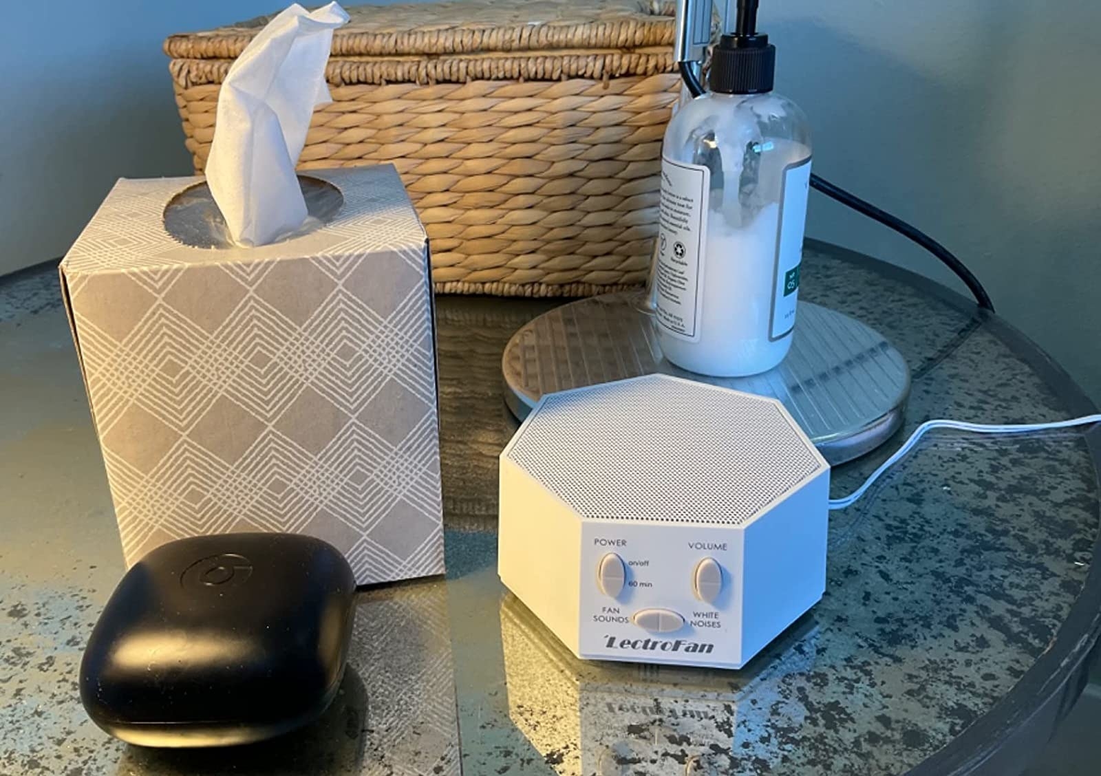 Reviewer&#x27;s photo of white heptagon-shaped noise machine on nightstand
