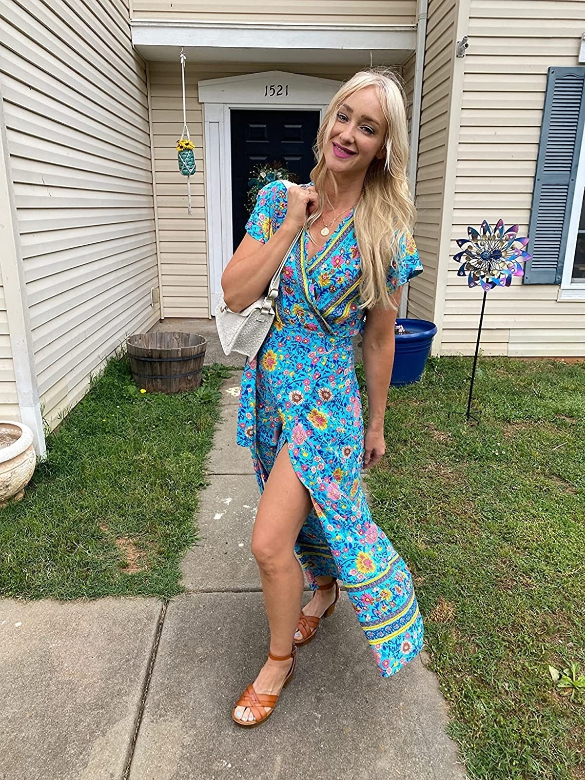 reviewer wearing short sleeve blue wrap maxi dress with pink and yellow flowers