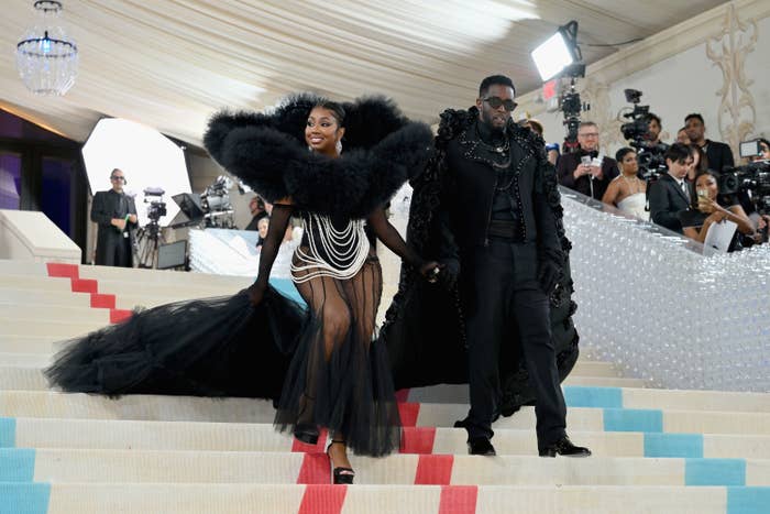 Yung Miami and Diddy descending the stairs at the Met Gala