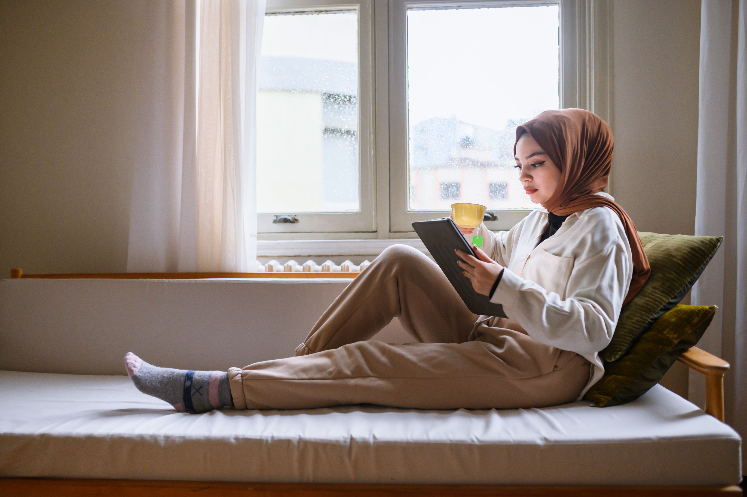 a woman reading a book in her phone