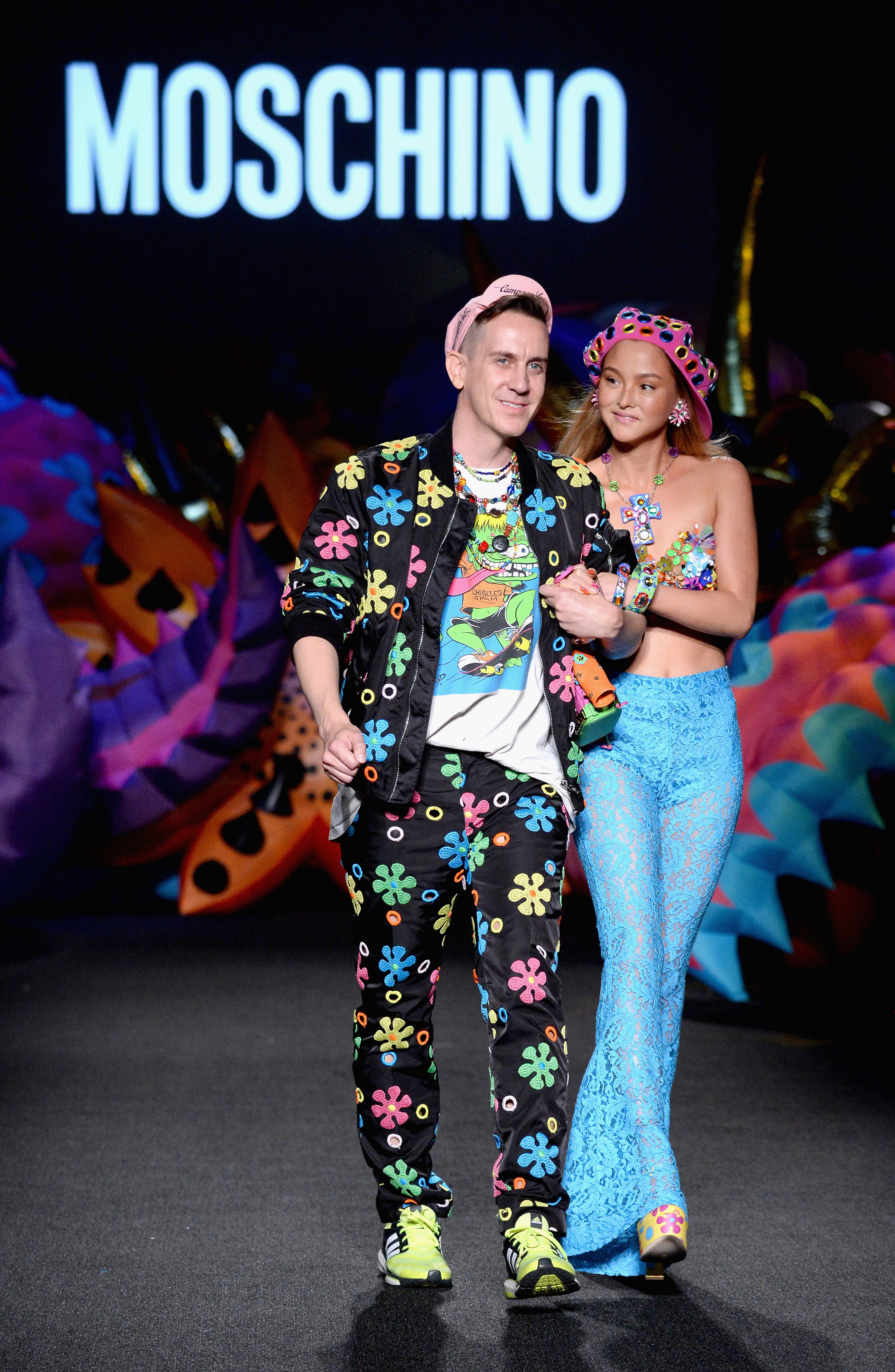 Jeremy Scott and Devon Aoki walking at the Moschino show in 2016