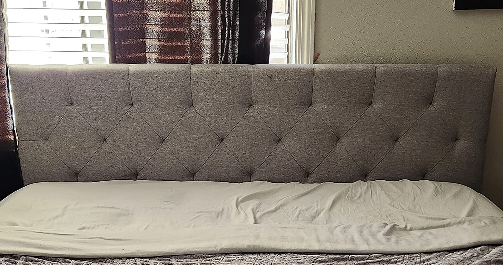 reviewer pic of the gray headboard