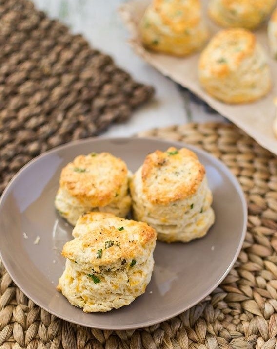 Garlic cheddar chive scones on a plate.