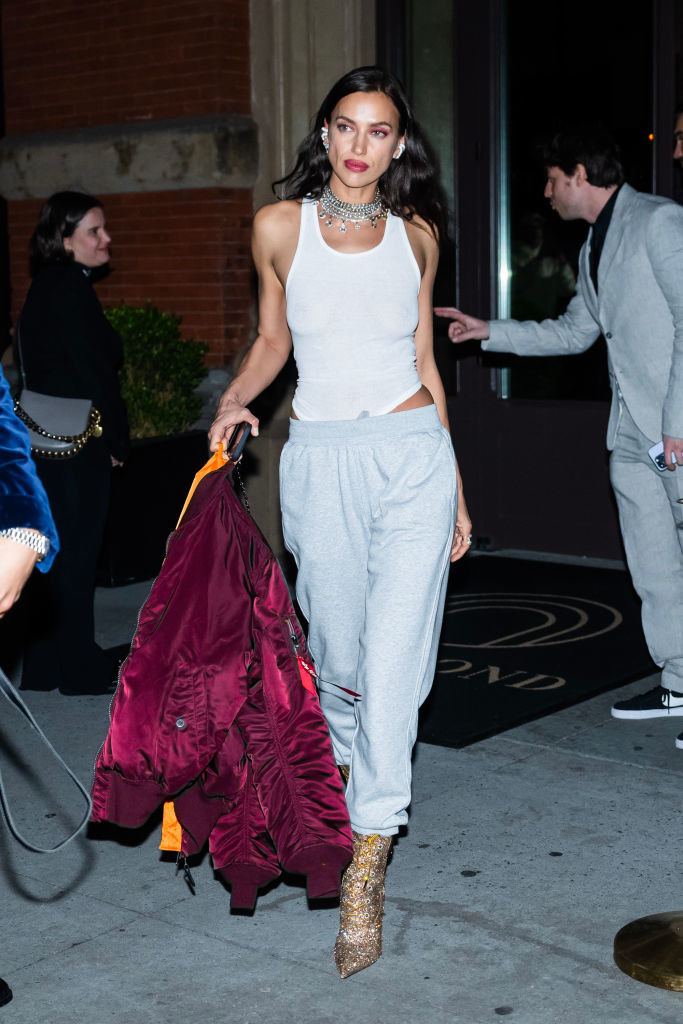 wearing sweatpants and a ribbed tank with glittery heeled boots