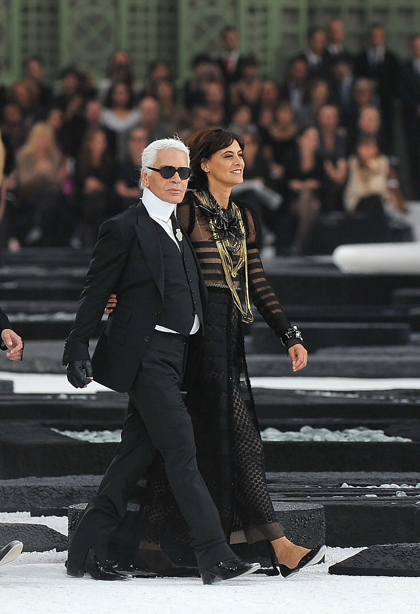A model, Baptiste Giabiconi, Karl Lagerfeld and Ines de la Fressange walk the runway during the Chanel Ready to Wear Spring/Summer 2011 show during Paris Fashion Week