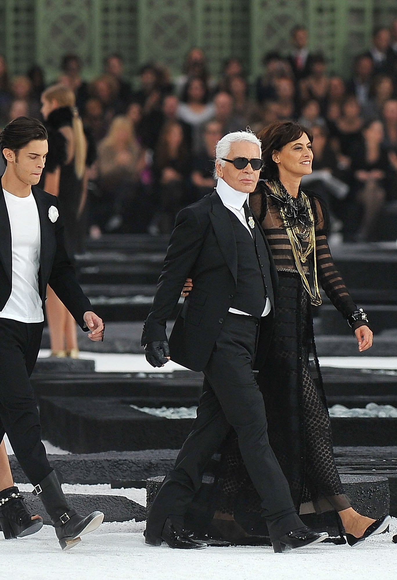A model, Baptiste Giabiconi, Karl Lagerfeld and Ines de la Fressange walk the runway during the Chanel Ready to Wear Spring/Summer 2011 show during Paris Fashion Week