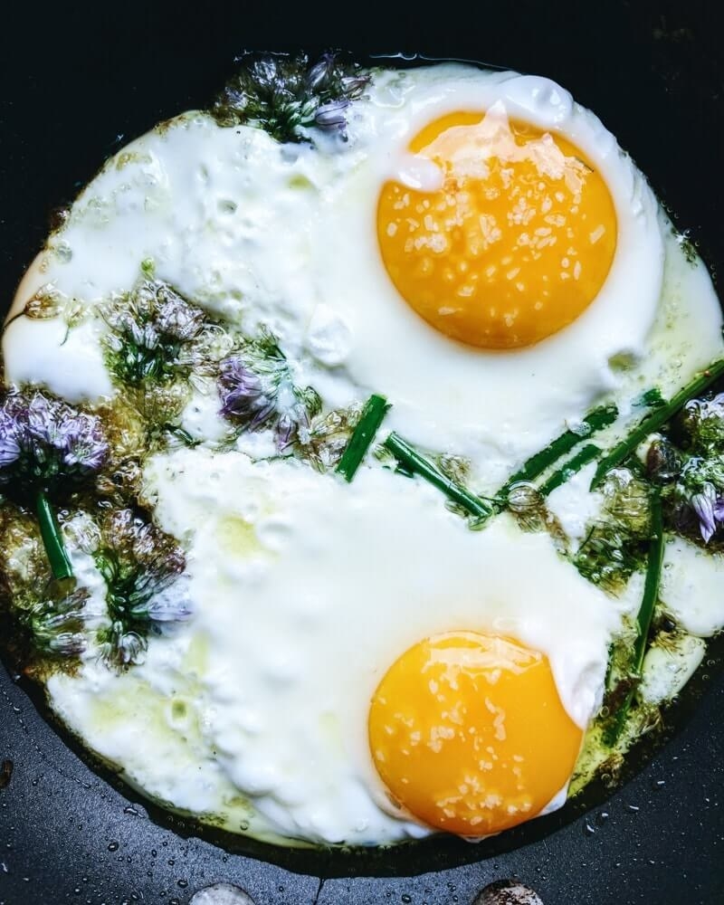 Fried eggs with chive flowers.