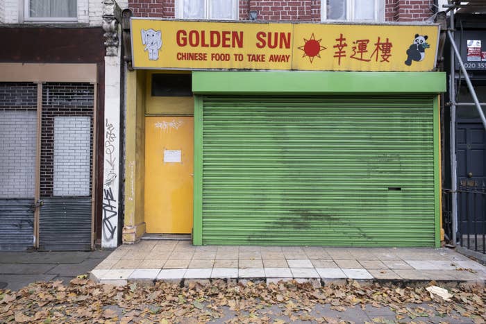 british chinese takeaway shop called golden sun with shutters down