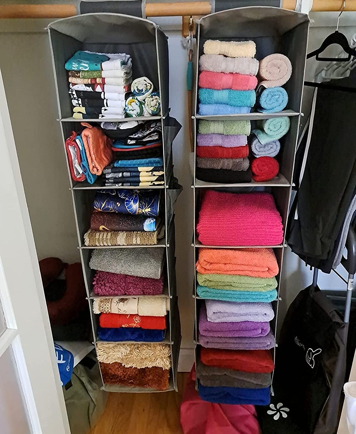 reviewer image of two of the closet organizers with clothes and towels in them