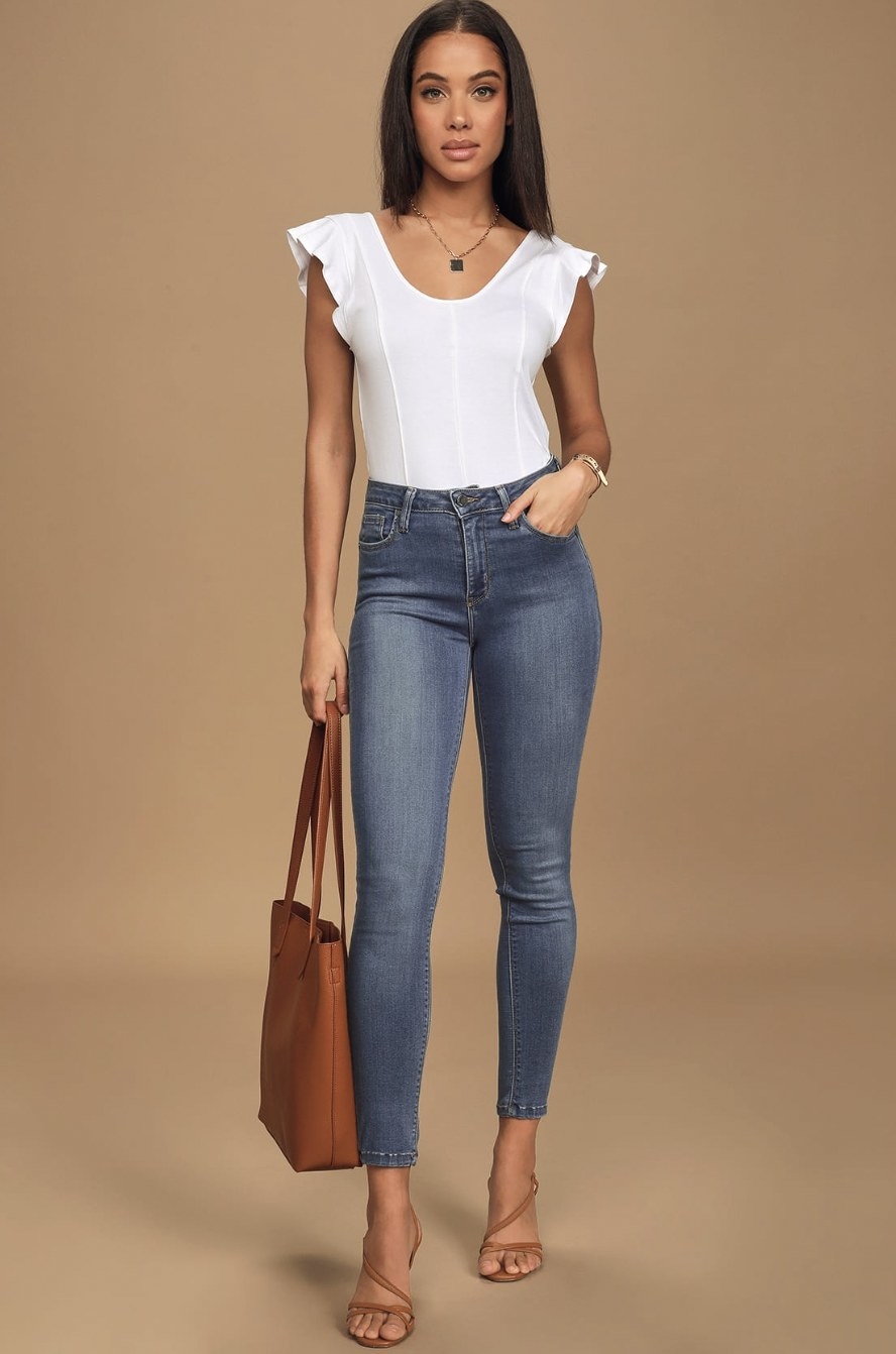 A model wearing the jeans with a white top