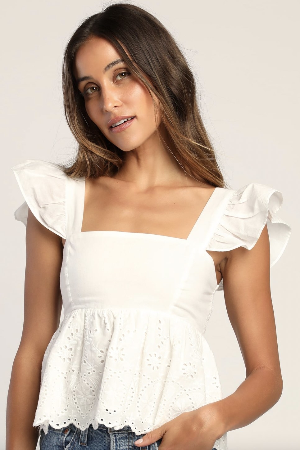 A model wearing a white peasant top