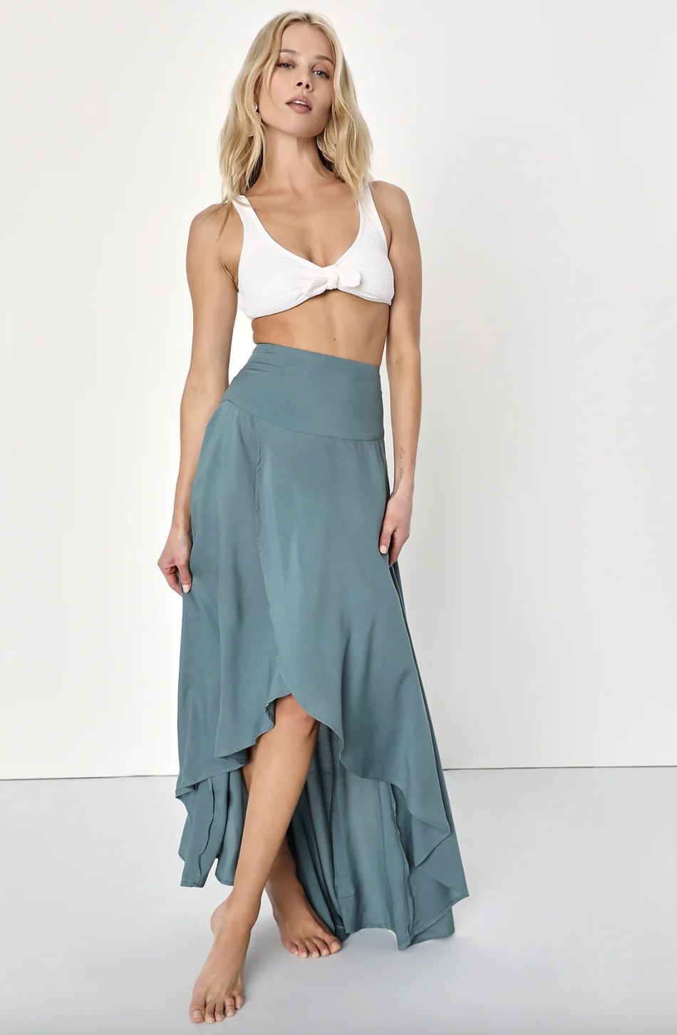 A model wearing the skirt in a grey blue color
