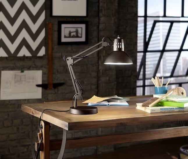 A black lamp on a desk in a home