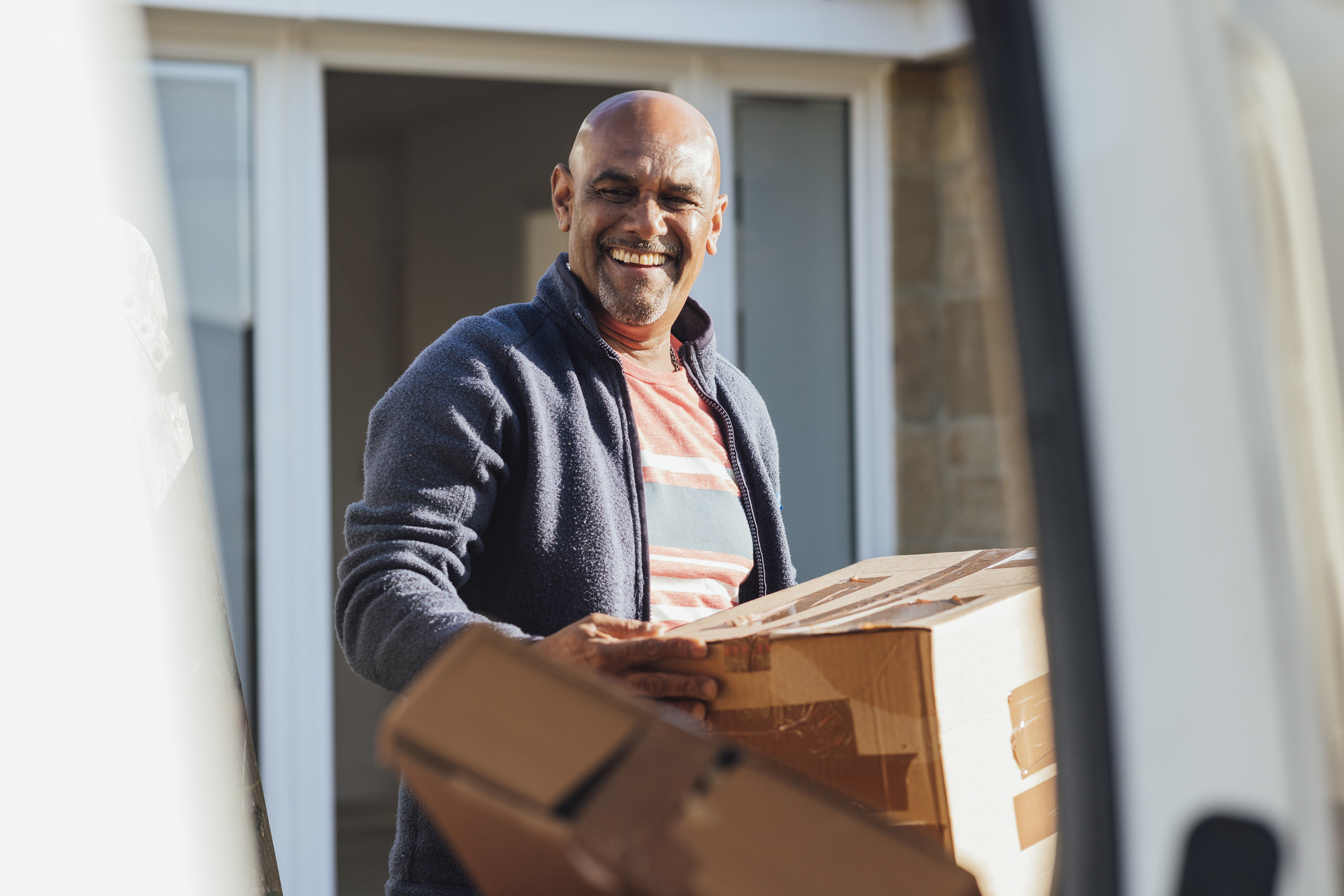 a man loading boxes onto a moving van