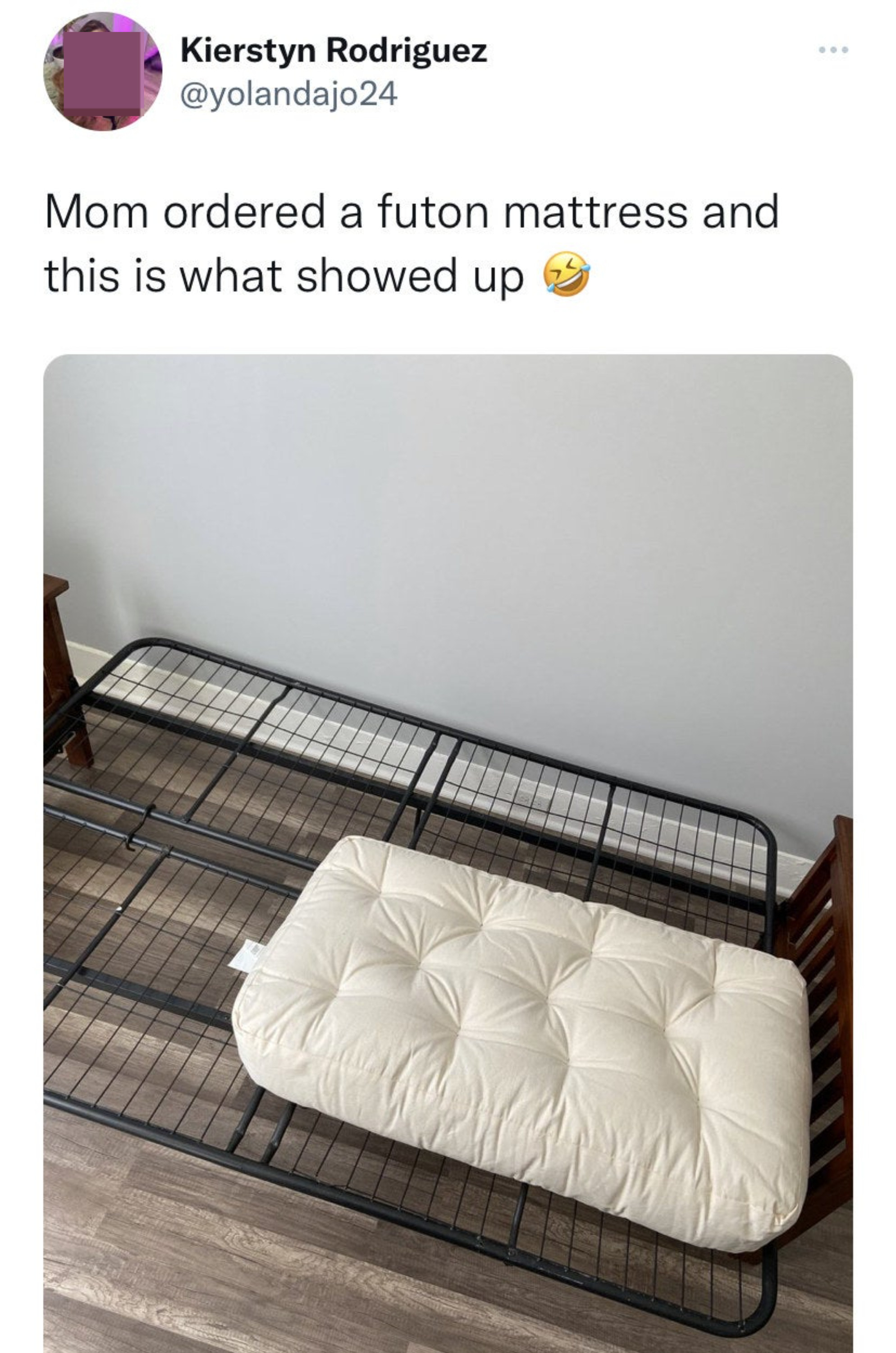 A tiny cushion on a futon