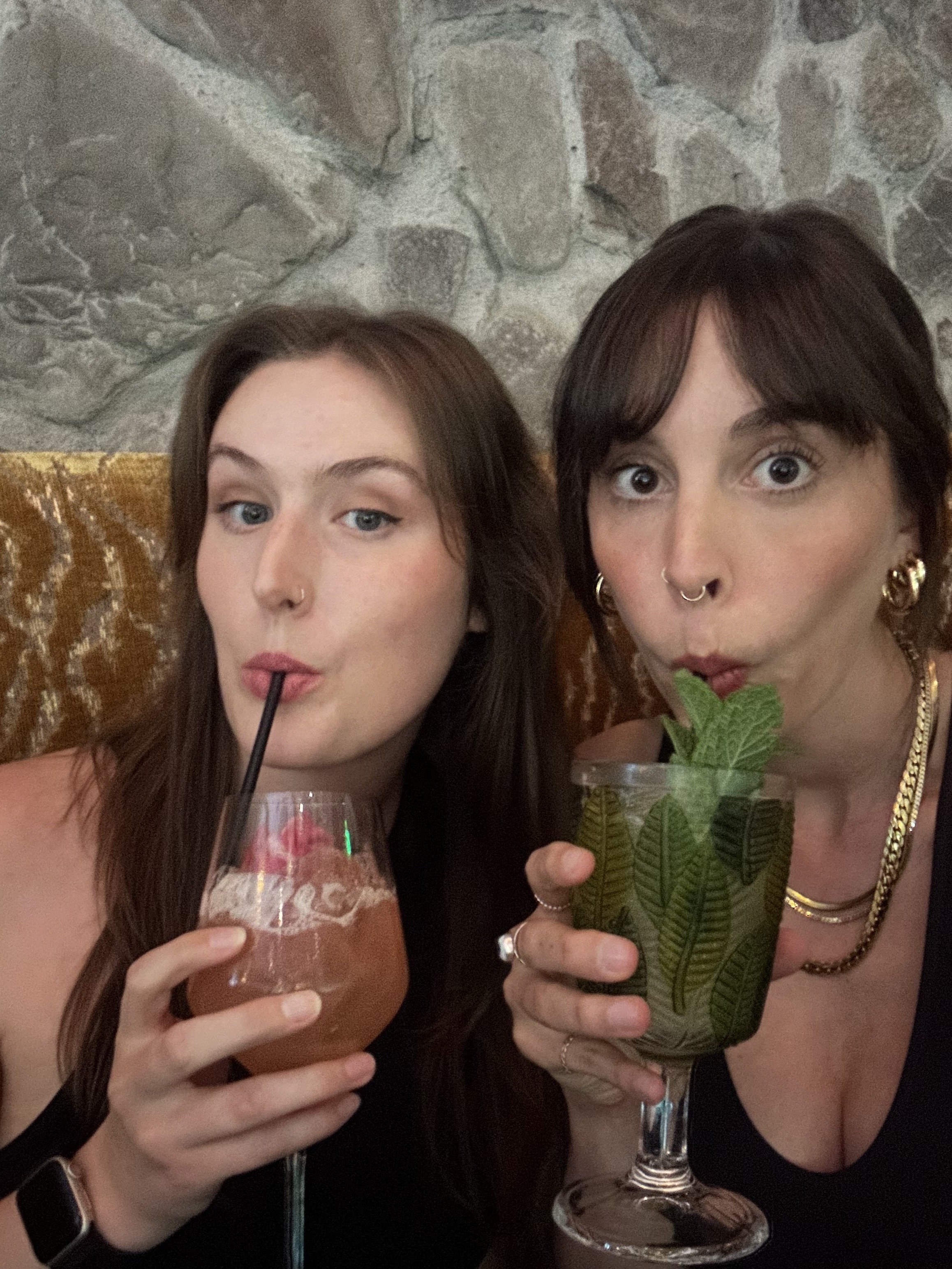 Shelby and Lara in a selfie drinking their cocktails