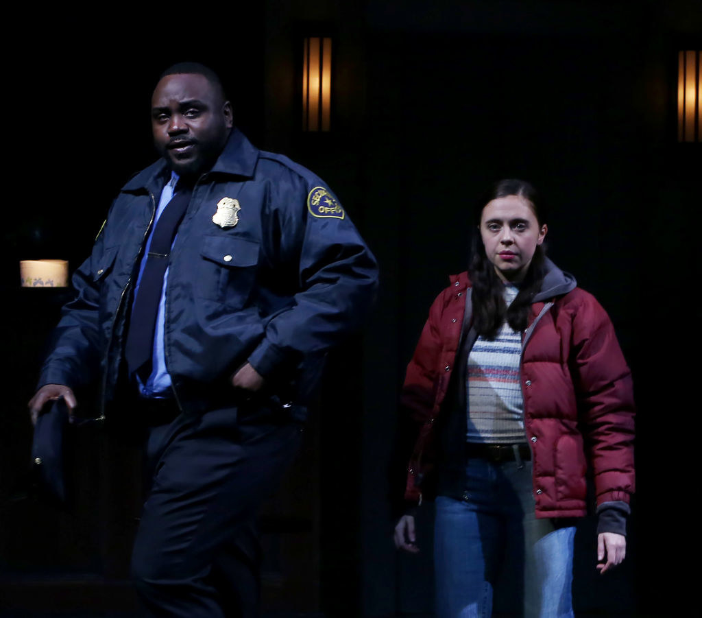 Brian wearing a cop uniform in the play as he stands next to a woman