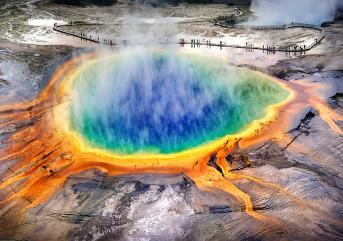 colorful hot spring with steam rising above