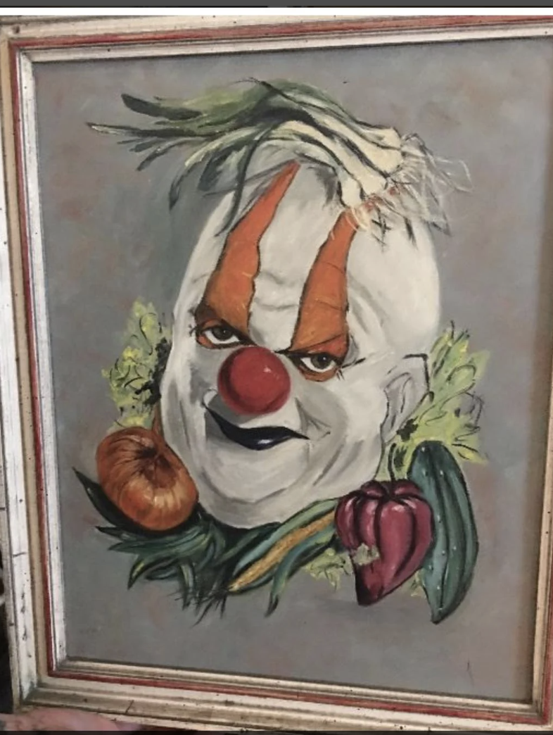 Framed painting of a menacing clown surrounded by vegetables